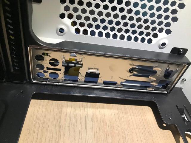 Align the IO shield with the rear panel of the case