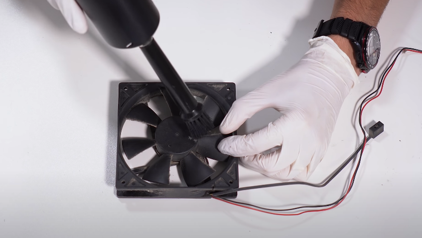 Use soft-bristled brush to clean a PC fan